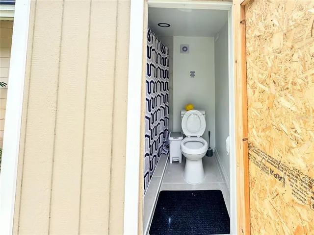 a backyard of a house with table and chairs
