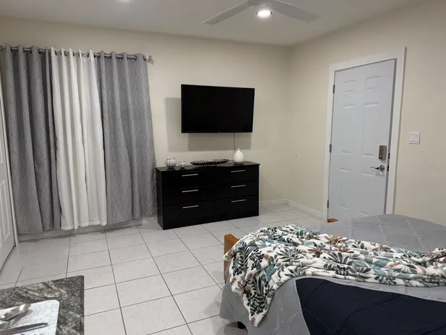 an aerial view of a house with a garden and trees