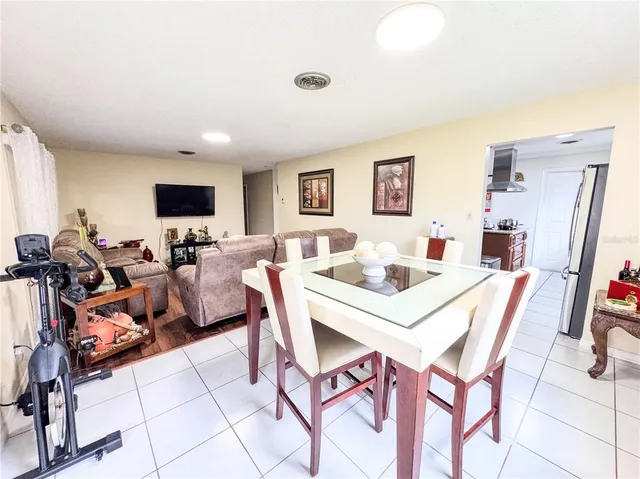 a kitchen with stainless steel appliances granite countertop a sink and a refrigerator