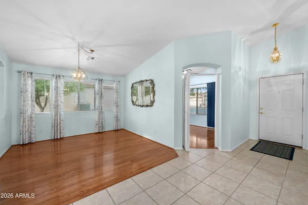 a view of an empty room with glass door and windows