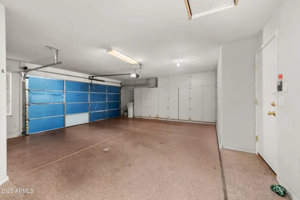 a utility room with cabinets washer and dryer