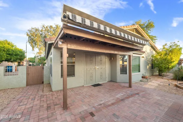 a backyard of a house with barbeque oven table and chairs
