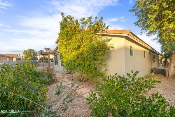 a view of a backyard with plants and a patio