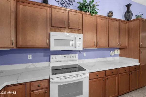 a kitchen with granite countertop cabinets stainless steel appliances and sink