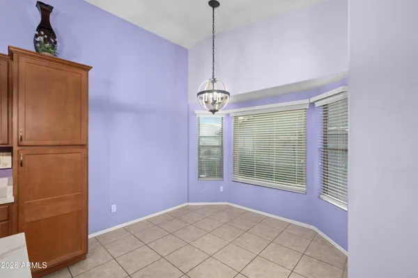 a kitchen with granite countertop cabinets a sink a stove and wooden floors