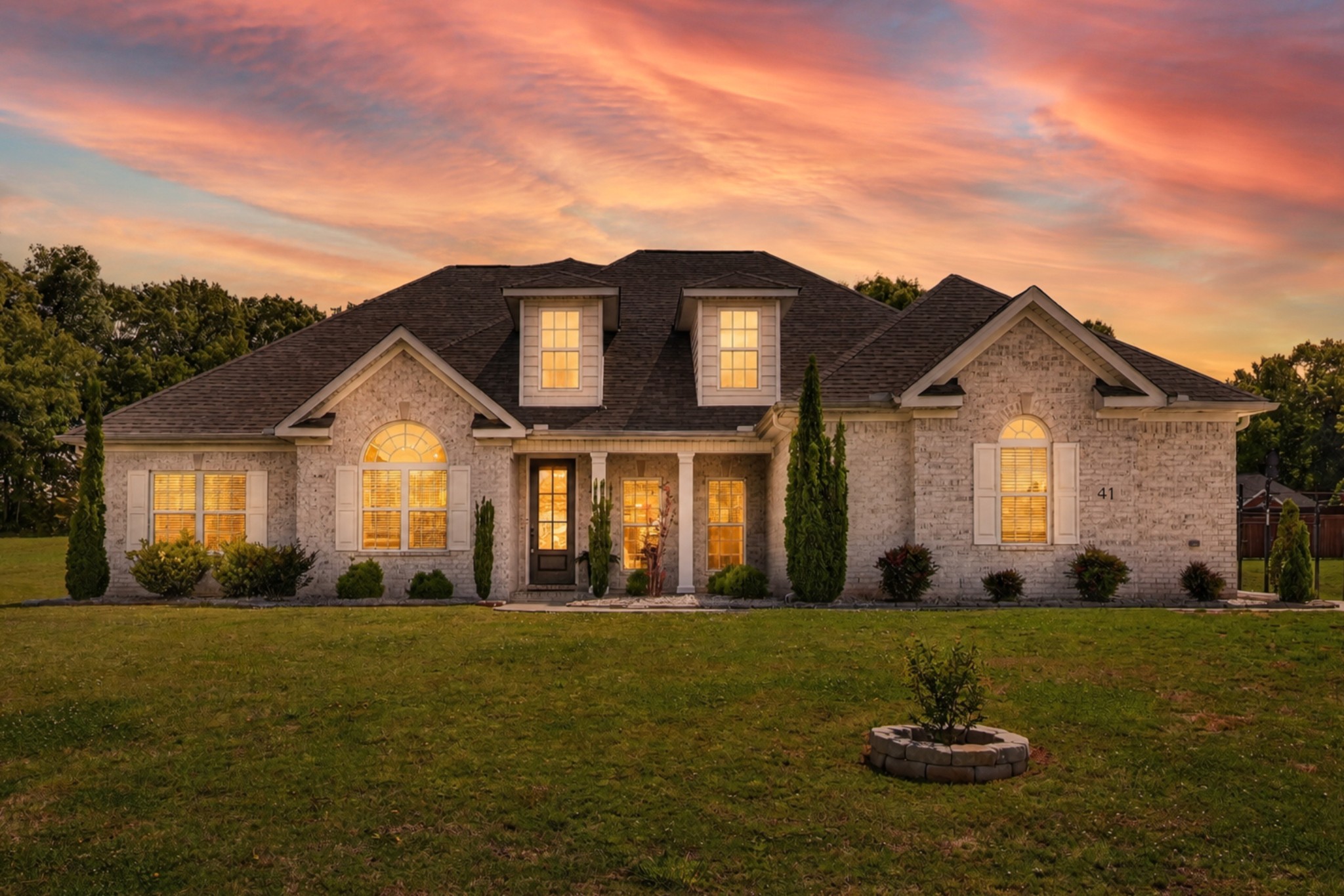 a front view of a house with a yard