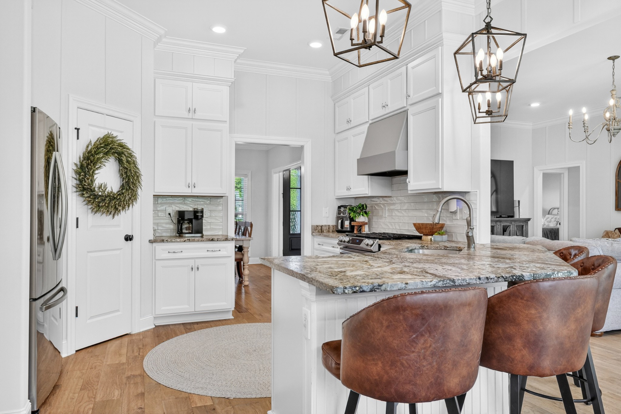 41 Knotting Hill Road Fayetteville, TN 37334 - Photo 19 of 65 a kitchen with stainless steel appliances granite countertop a sink a stove a refrigerator a microwave oven with white cabinets and wooden floor
