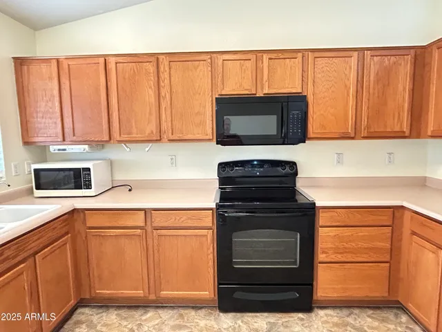 a kitchen with a cabinets and appliances
