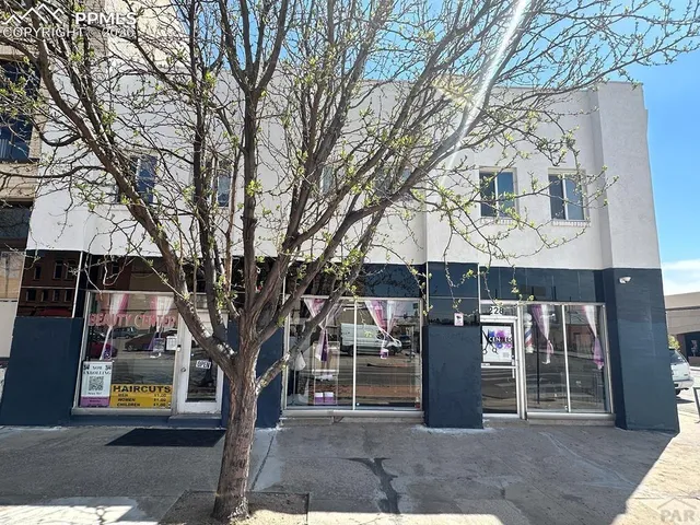 a room with water heater and a wooden door