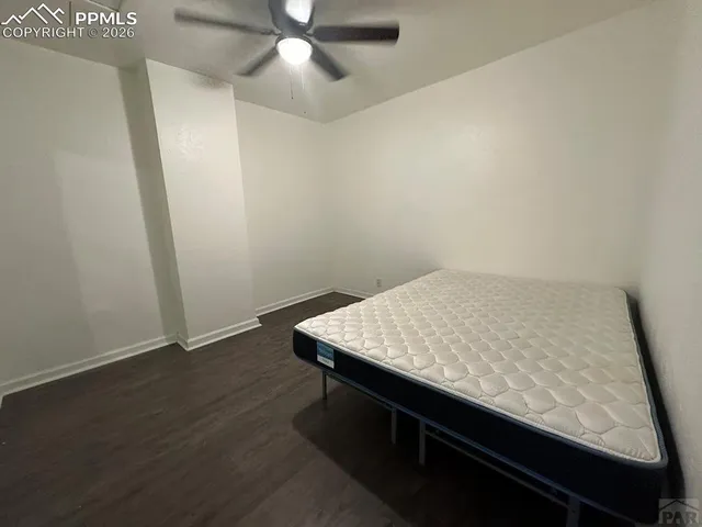 a living room with furniture and a ceiling fan