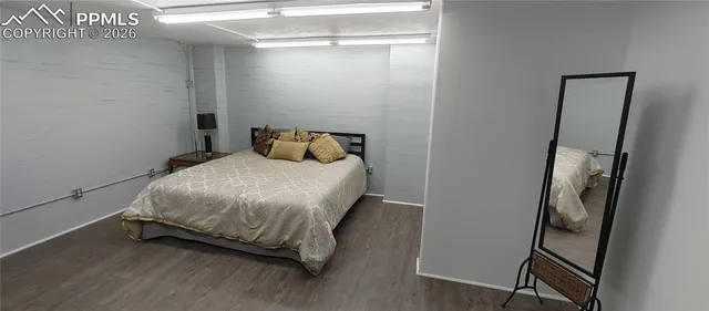 a bedroom with a bed and a mirror