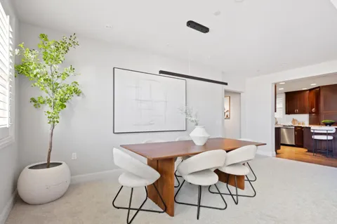 a dining room with furniture and wooden floor