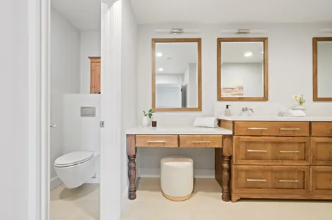 a bathroom with a sink toilet and mirror