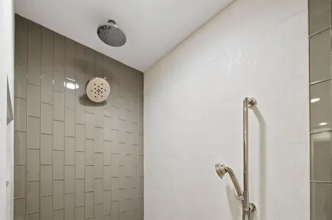 a bathroom with a shower and a mirror