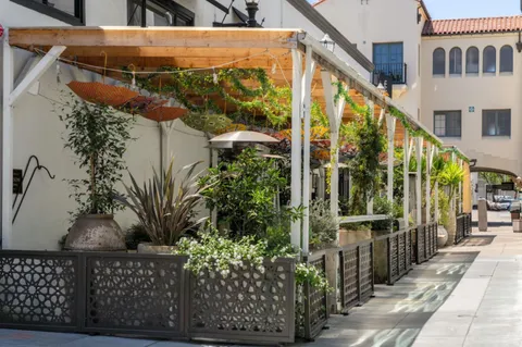 an aerial view of residential houses with outdoor space and parking