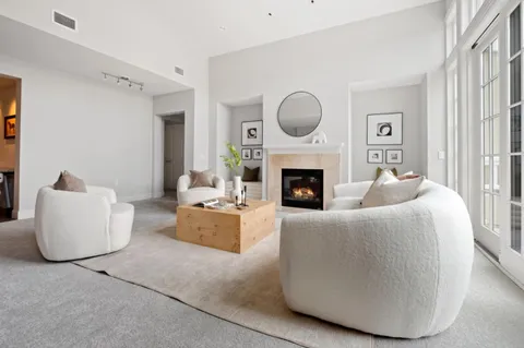 a living room with furniture a fireplace and a window