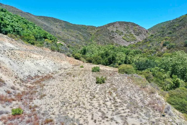 a view of a mountain with a mountain in the background