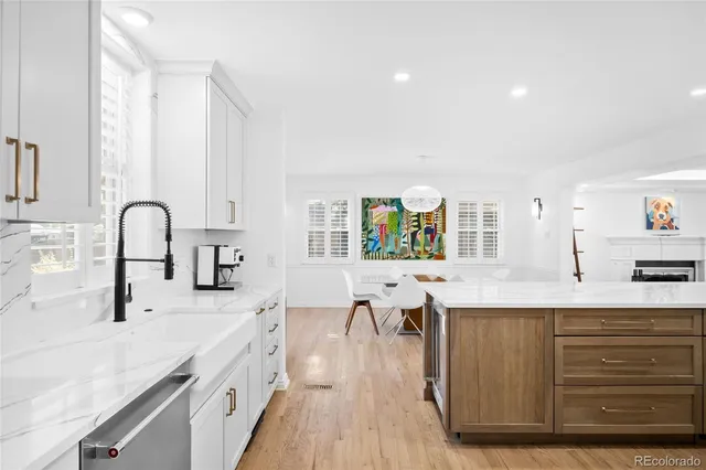a kitchen with counter top space a sink cabinets and wooden floor