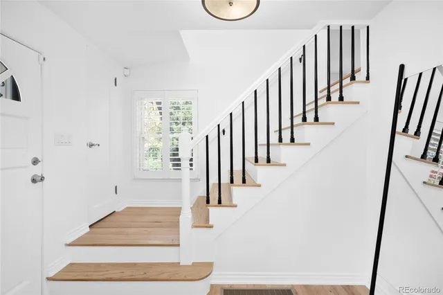 a view of entryway and hall with wooden floor