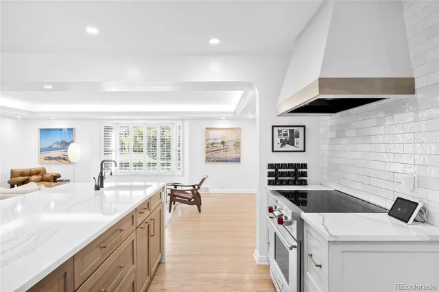 a kitchen that has a sink and a stove in it