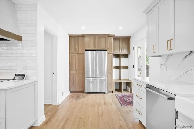 a kitchen with stainless steel appliances a refrigerator and a stove top oven