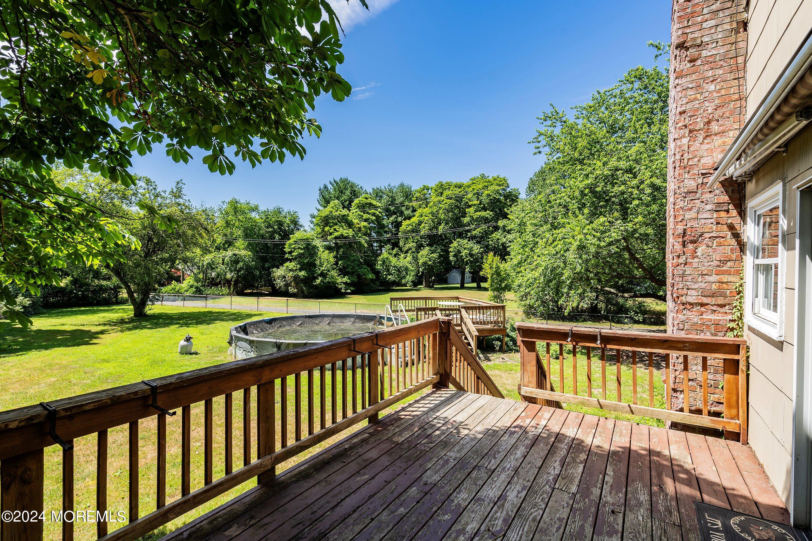 354 Colts Neck Road Farmingdale, NJ 07727 - Photo 5 of 30 a view of balcony with wooden floor and fence