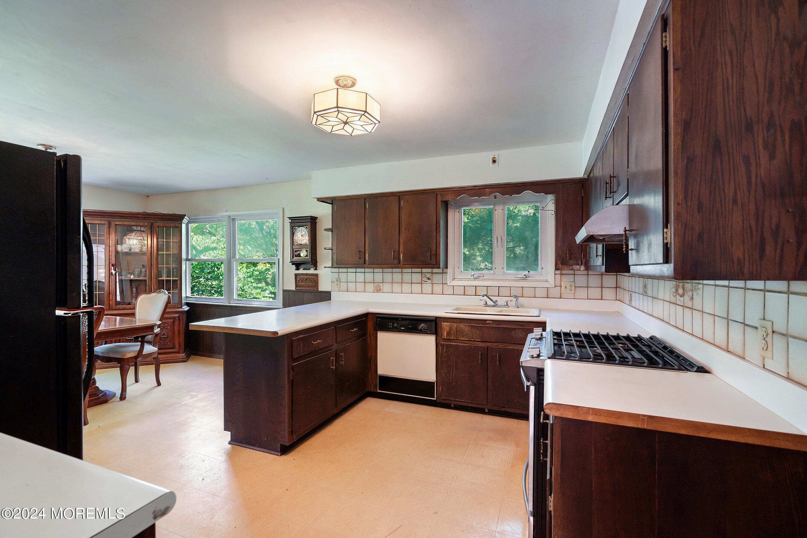354 Colts Neck Road Farmingdale, NJ 07727 - Photo 10 of 30 a kitchen with stainless steel appliances granite countertop sink stove and cabinets