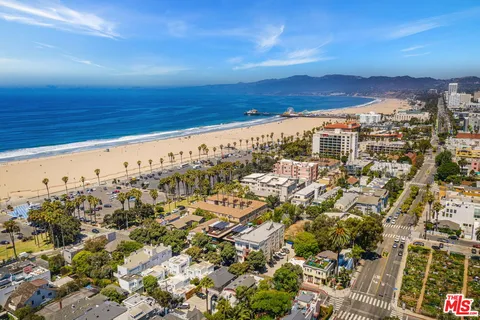 a view of a white house with a yard