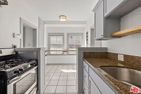 a kitchen with a stove a sink and a refrigerator