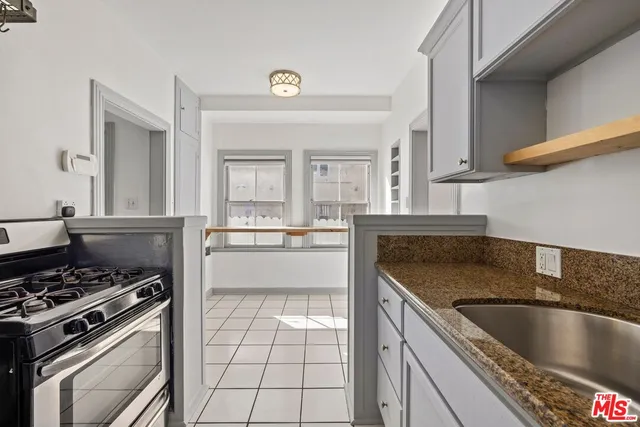a kitchen with a stove a sink and a refrigerator