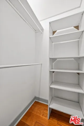 a view of walk in closet with empty racks