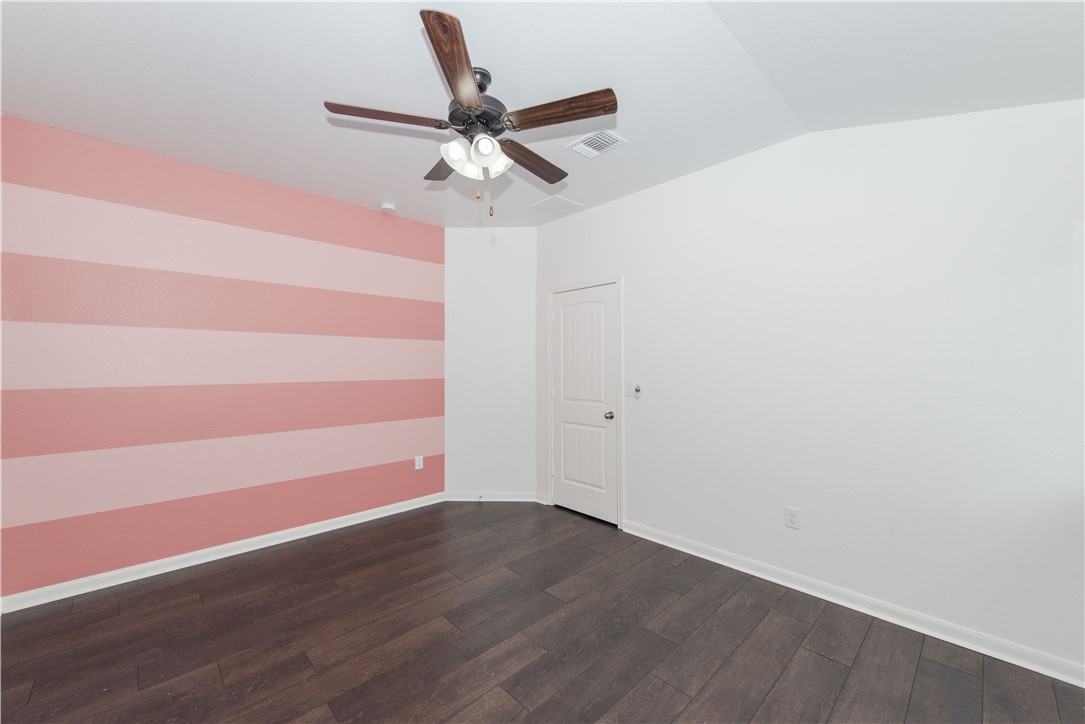 1007 Plateau Trail Georgetown, TX 78626 - Photo 22 of 32 a view of a room with wooden floor and a ceiling fan