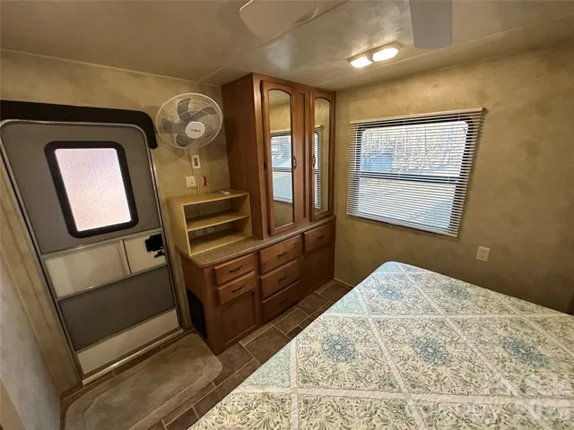 a view of an empty room and wooden floor