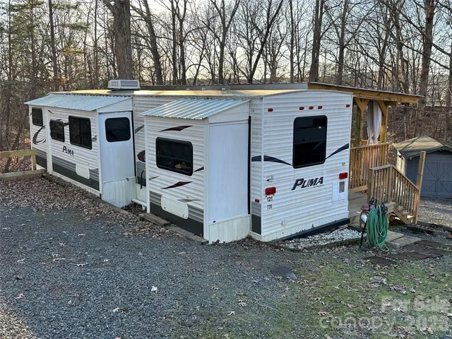 a view of a white house with a large space in front of it