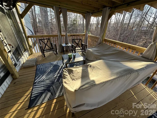 a view of a living room and balcony with furniture