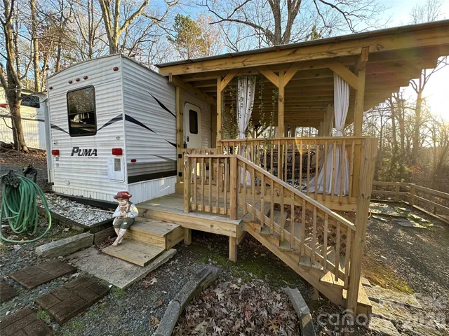 a view of a house with backyard and wooden floor