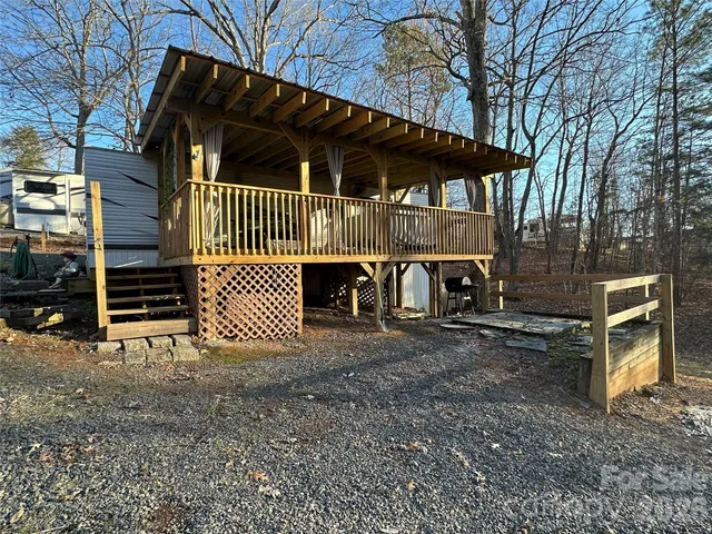 a view of a house with a yard and wooden fence
