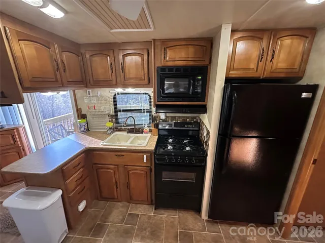 a kitchen with a sink appliances and cabinets