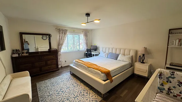 a bedroom with a bed and a dresser in it