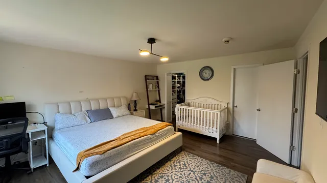 a bedroom with a bed and a couch