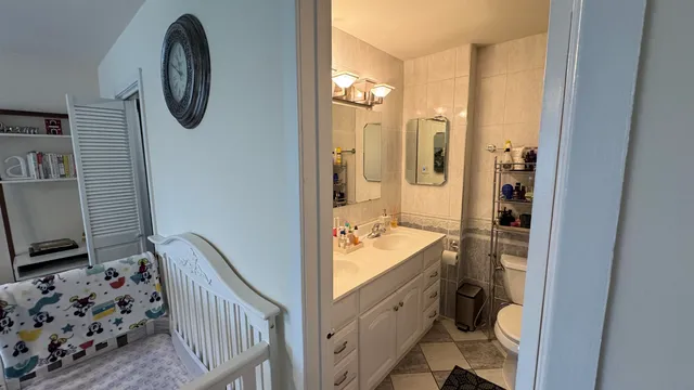 a bathroom with a toilet a sink and a mirror