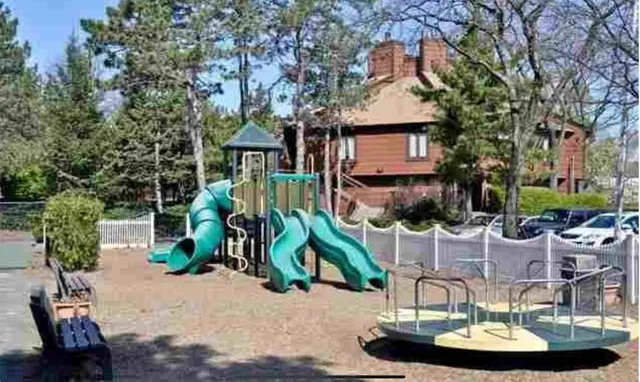 a view of a chairs and table in backyard