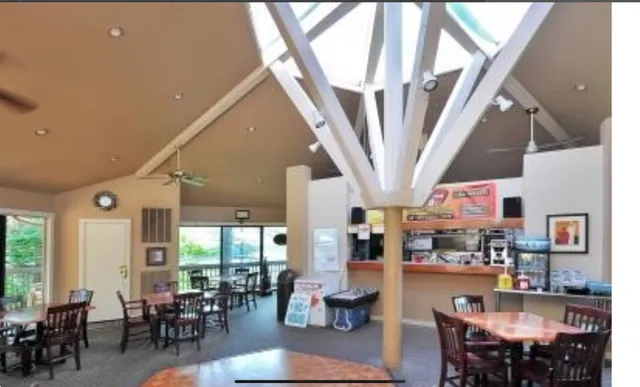 a living room with lots of furniture and large window