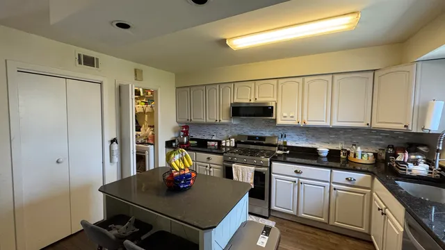 a kitchen with a stove a sink and a refrigerator
