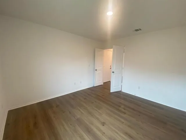 an empty room with wooden floor