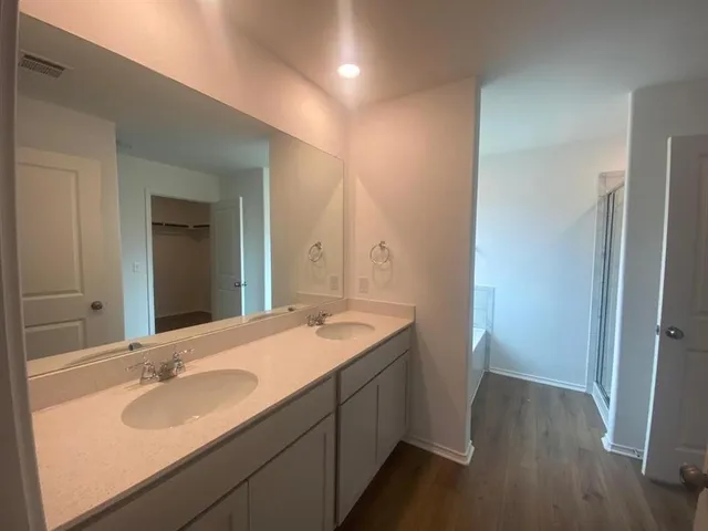 a bathroom with a sink and a large mirror
