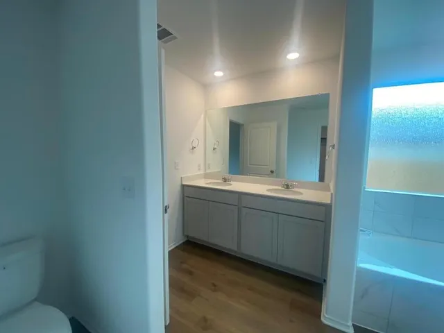 a bathroom with a granite countertop sink mirror and toilet