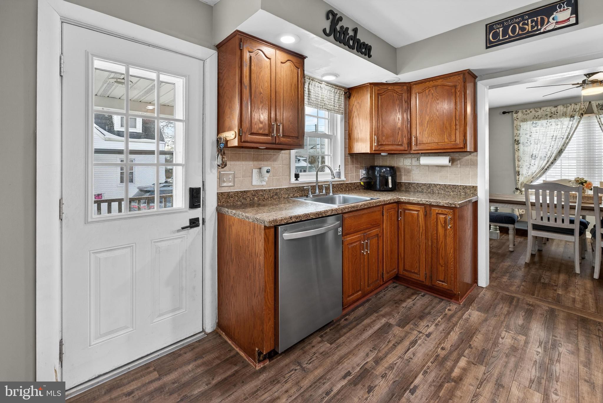 115 South Walnut Avenue Maple Shade, NJ 08052 - Photo 11 of 30 a kitchen with stainless steel appliances granite countertop a refrigerator a sink dishwasher a stove with wooden cabinets and floor
