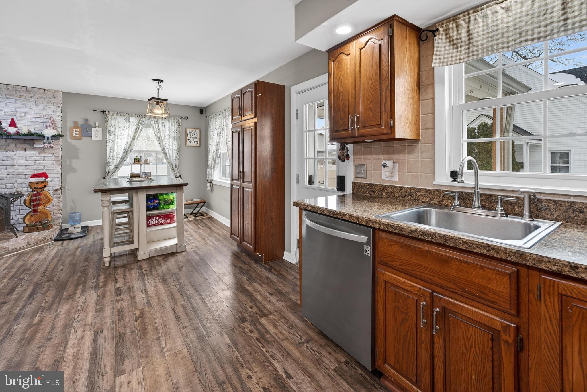 115 South Walnut Avenue Maple Shade, NJ 08052 - Photo 13 of 30 a kitchen with stainless steel appliances granite countertop a sink dishwasher stove and refrigerator with wooden floor