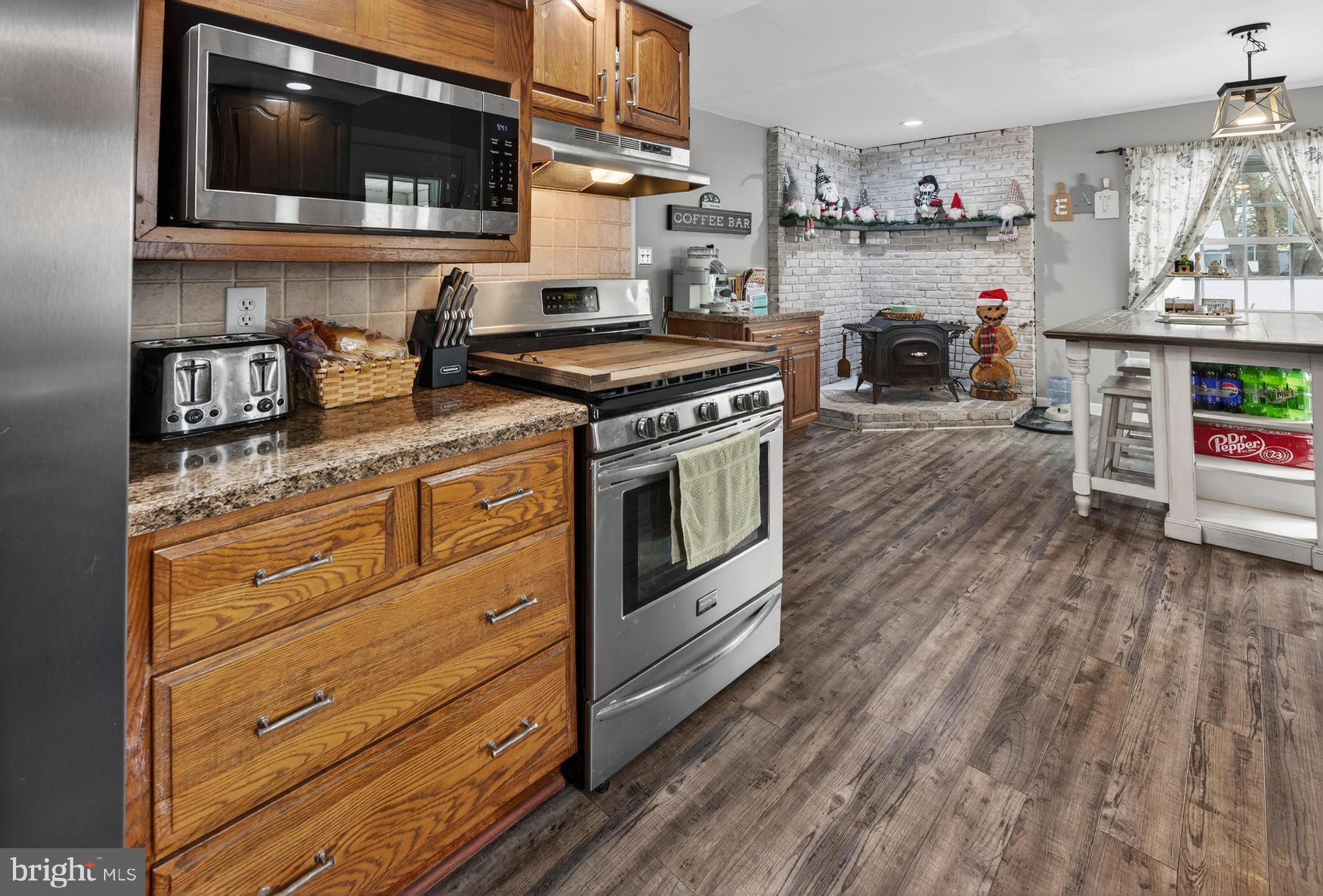 115 South Walnut Avenue Maple Shade, NJ 08052 - Photo 14 of 30 a kitchen with stainless steel appliances granite countertop a stove and a wooden floors